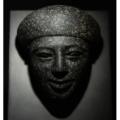 Avers, pour Egyptian, Late period — Sarcophagus mask depicting a youthful face with idealised features, a bag wig hairstyle...