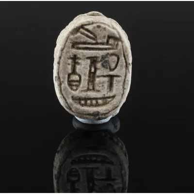 Obverse, for Egyptian — Scarab with ideograms (including nefer = “luck”, djed-pillar = “endurance”, ankh = “life”, as a wish...