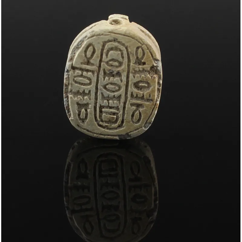Obverse, for Egyptian — Scarab with pseudo-hieroglyphic (schematic signs of the “anra”- type in a schematic cartouche ring)...