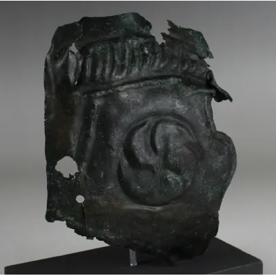 Obverse, for Roman — Military cheek piece of a helmet fragment with shield ornament — 3rd Century A.D, 3rd Century A.D