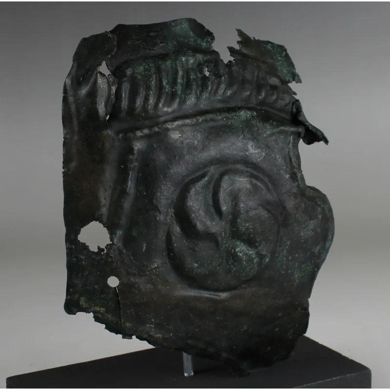 Obverse, for Roman — Military cheek piece of a helmet fragment with shield ornament — 3rd Century A.D, 3rd Century A.D